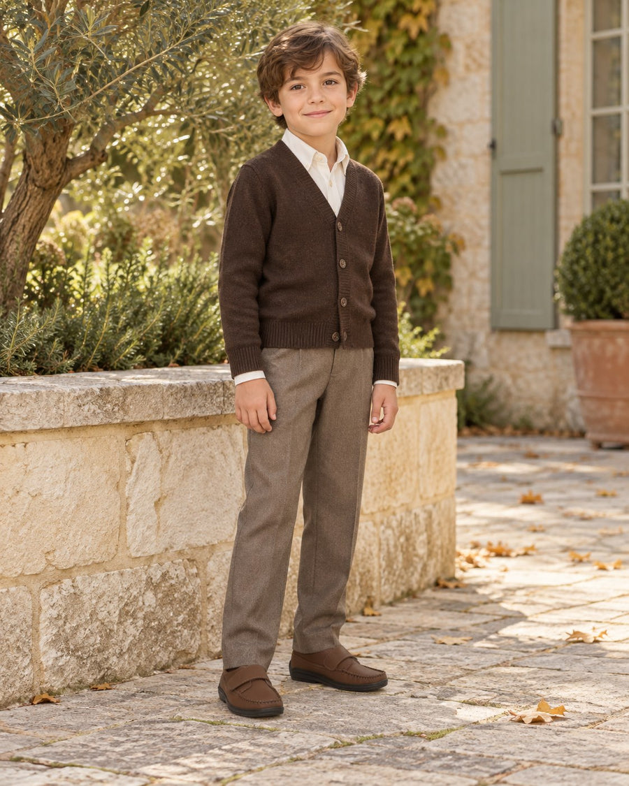 Boy in a brown cardigan and tailored trousers wearing London Kids brown strap shoes.